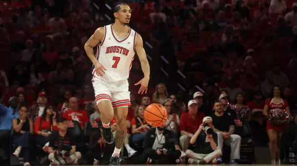 Milos Uzan Dribbles basketball