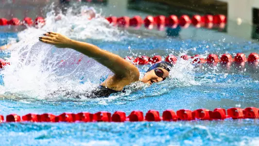 Freshman Asli Bozer swimming the freestyle against Rice