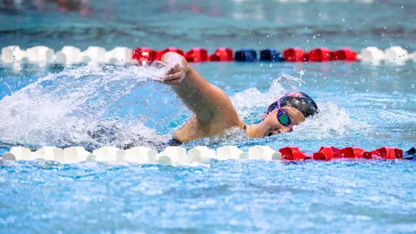 Freshman Emma Overall swimming the freestyle