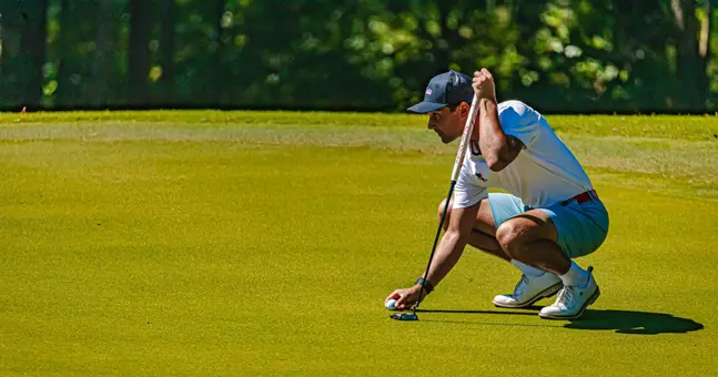 Hudson Weibel lining up his putt on green at Argent Financial Classic