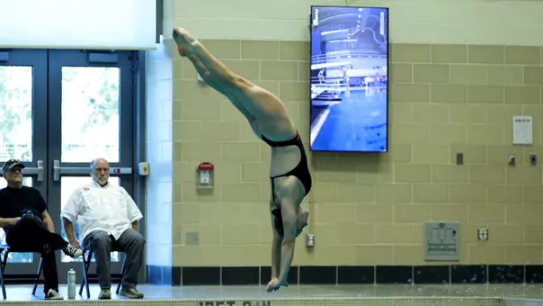 Freshman Maisy Woloszyn diving off the 3-meter springboard
