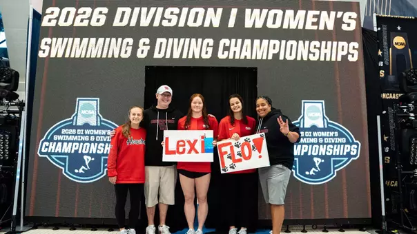 From Left to Right: Casey Kyriacopoulos, Allan McCollum, Alexia Duncan, Virag Peter, and Tanica Jamison pose in front of the NCAA Championships sign