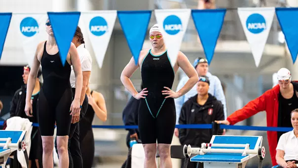 Sophomore Alexia Duncan standing with her hands on her hips on the pool deck preparing to compete in the 200-yard backstroke at the NCAA Championships