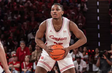 Mercy Miller holding a basketball and looking to pass