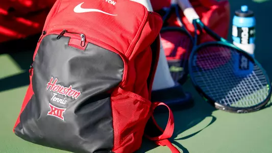 Stock photo of backpack that reads Houston Tennis and a tennis racquet