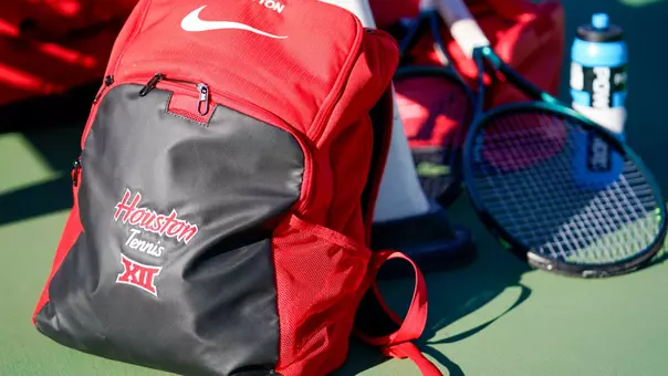 Stock photo of backpack that reads Houston Tennis and a tennis racquet