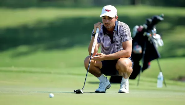 Hudson Weibel lines up his putt on the green