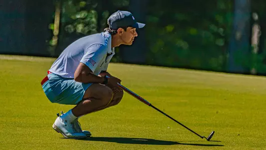 Hudson Weibel lines up his putt on the green