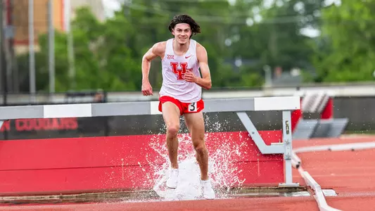 Patrick Flowers running in water during steeplechase