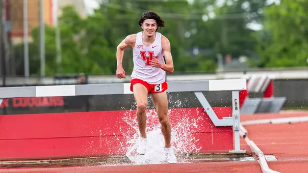 Patrick Flowers running in water during steeplechase
