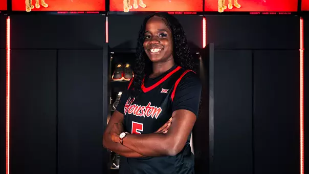 Elodie Lutbert smiling with arms crossed in front of locker
