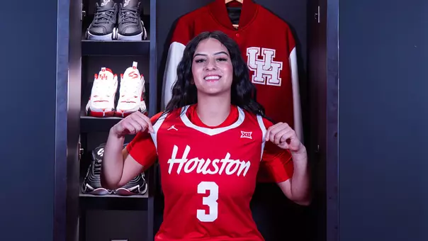 Esmerelda Enriquez wearing jersey and pointing it out