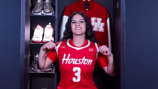 Esmeralda Enriquez wearing jersey and pointing it out