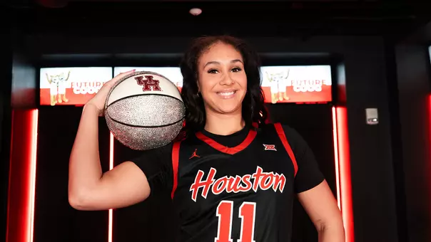 Justice Carlton smiling and basketball on her shoulder