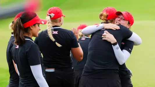 Natalie Saint Germain is hugged by teammates following her Final Round at Big 12 Championship