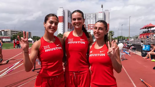 Evina Panagiotou, Aubrey Tupper, Nicole Prall standing together and holding hands up with the Cougar paw sign
