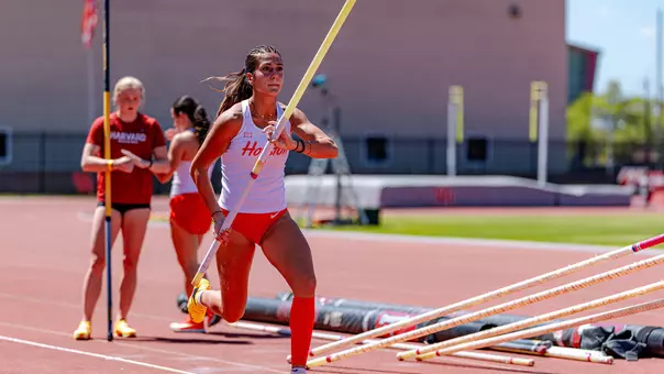 Evina Panagiotou running with pole vault in her hand