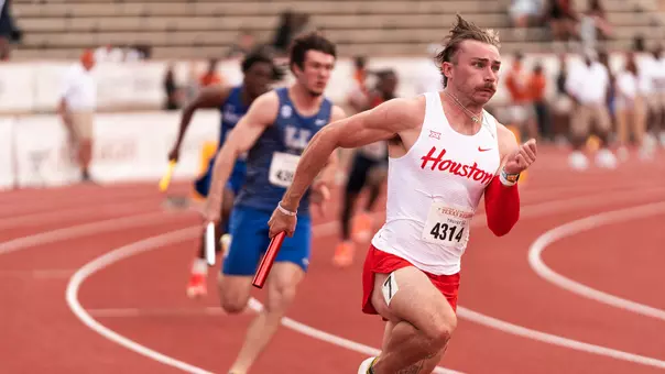 Ryan Mulholland running with baton at Texas Relays