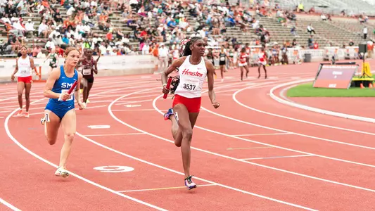 Carlysia Cresser running with baton