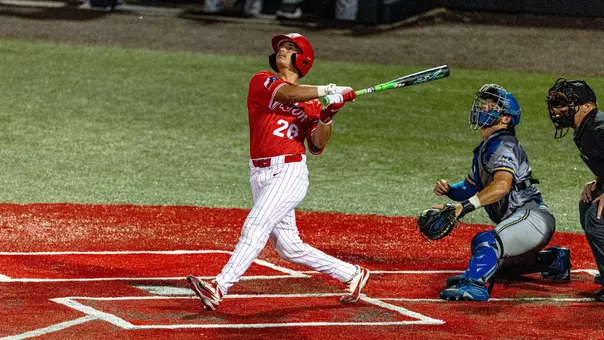Dylan Maxcey watches his hit after swinging