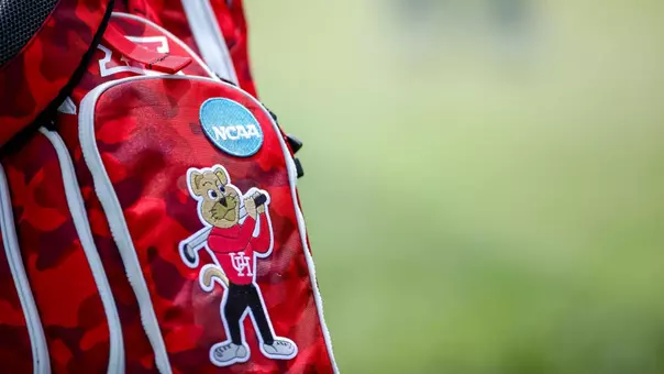 Houston Cougars golf bag sits near green