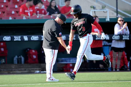 Tre Broussard high fives Kyle Cheesebrough rounding third after hitting a homer