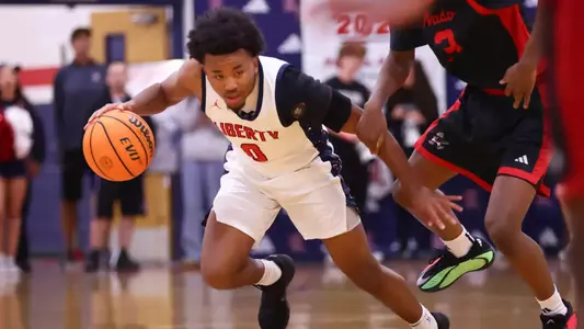 Signee Tyus Thomas dribbles a basketball during a game with Liberty High School