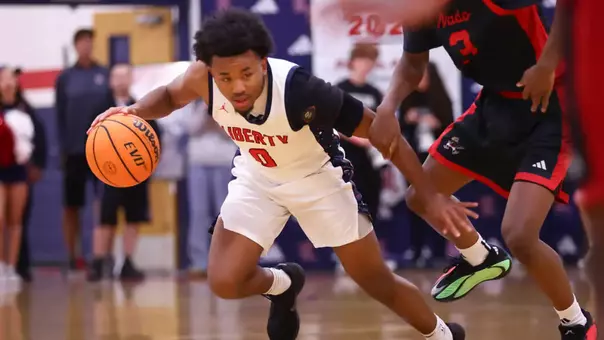 Signee Tyus Thomas dribbles a basketball during a game with Liberty High School