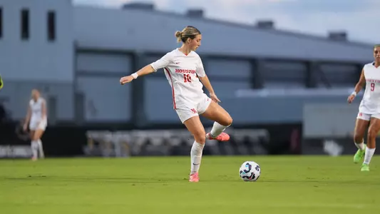 Juliet Moore kicks a soccer ball