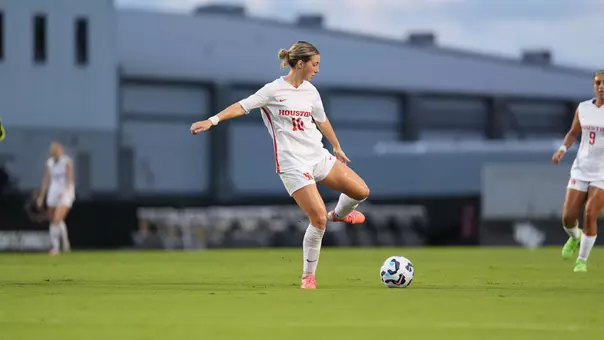 Juliet Moore kicks a soccer ball