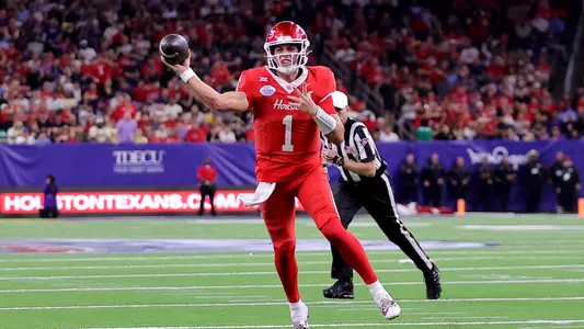 Conner Weigman throws the ball off one leg during Texas Bowl vs. LSU