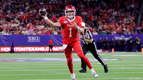 Conner Weigman throws the ball off one leg during Texas Bowl vs. LSU