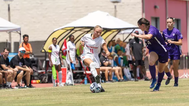 Skylar Miller dribbles soccer ball past defender