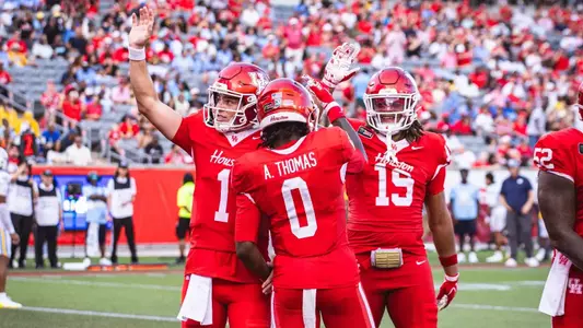 Conner Weigman, Amare Thomas and Kaleb Thomas celebrating together after a touchdown