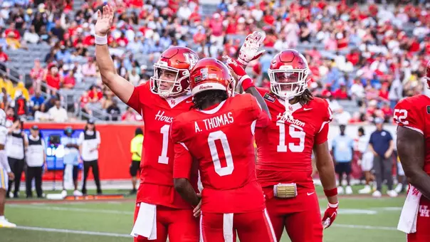 Conner Weigman, Amare Thomas and Kaleb Thomas celebrating together after a touchdown