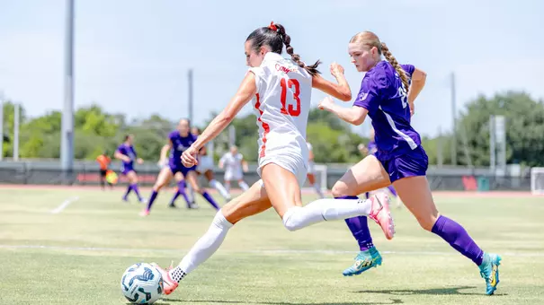 Laney Gonzales kicks a soccer ball