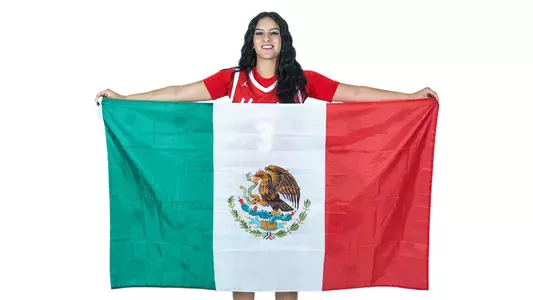 Esmeralda Enriquez holding up Mexico flag