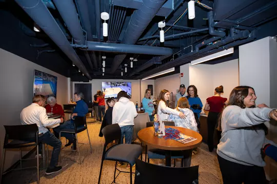 LAWRENCE, KS - December 1, 2023 - David Booth and family before the game between the Kansas Jayhawks and the UConn Huskies. Photo by Angilo Allen/Kansas Athletics