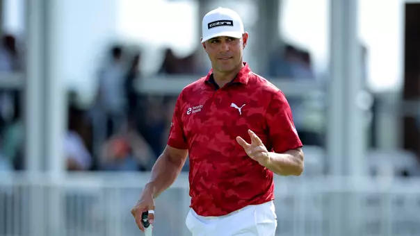 Mar 29, 2025; Houston, Texas, USA; Gary Woodland acknowledges the spectators while walking up to the green on the 18th hole during the third round of the Texas Children's Houston Open golf tournament. Mandatory Credit: Erik Williams-Imagn Images