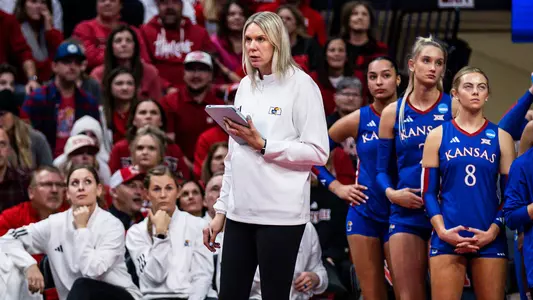 Lawrence, KS - December 12, 2025 - Associate Head Coach Erika Dillard during arrival against Nebraska at Bob Devaney Sports Center in Lincoln, NB. Photo by Bailey Thompson/Kansas Athletics