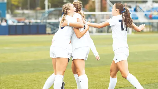 Maine soccer celebrates a goal against Bryant.