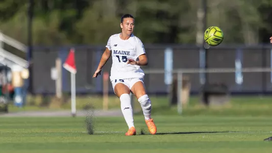 Melina Peloteau kicks the ball up the field.