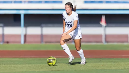 Sophia Santamaria dribbles the ball up the field.