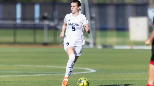 Luise Reinwald dribbles the ball up the field.