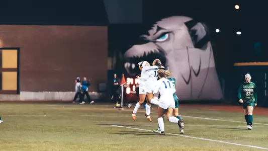 Maine celebrates a goal against Vermont.