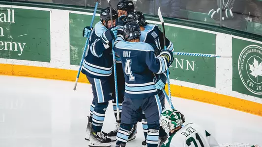 Maine men's hockey celebrates a goal against Dartmouth.