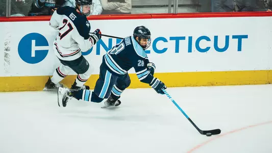 Anthony Calafiore takes the puck off the wall against UConn.