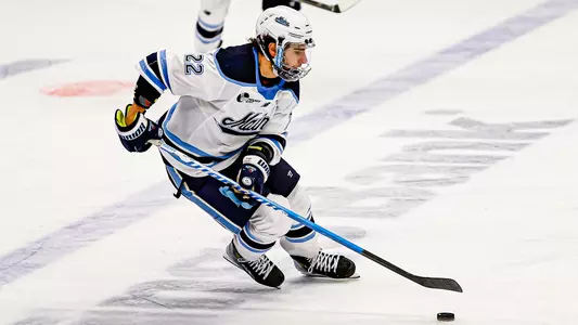Harrison Scott carries the puck through the neutral zone.