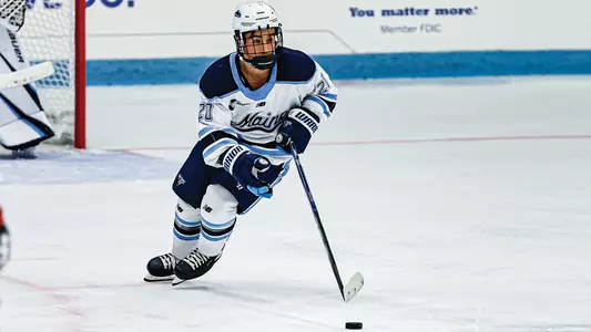 Josh nadeau carries the puck through the defensive zone.