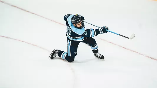 Reid Pabich shoots the puck.